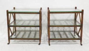 Pair of hardwood three-tier and glass-topped side tables, on castors (2)  Condition ReportWidth 51