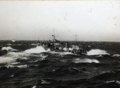 Black and white photograph of a battleship in stor