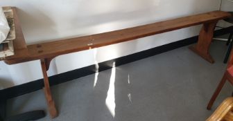 Pair of 19th century French cherrywood long benches on trestle end supports (2)