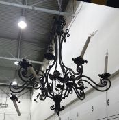 Wrought metal six-branch electrolier of openwork and floral form, having six twin reflex scroll