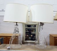 Pair of clear glass bodied table lamps, cream shades