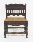 Anglo Indian style cane seated chair, the elaborately carved back and rail on barleytwist supports