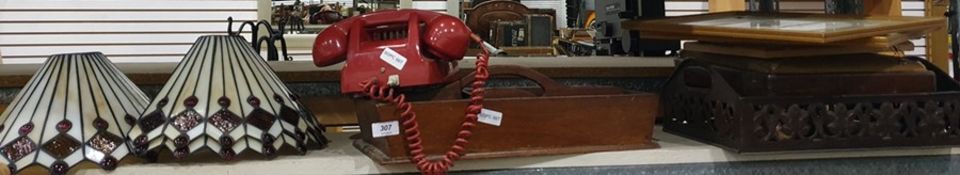 Red plastic dial telephone, three Tiffany style lampshades, wooden cutlery tray, assorted prints,