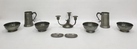 Various pewter items including two tankards with glass bases, a three-branch candelabra of Arts &