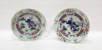 Pair of Chinese porcelain plates, each with lakeside landscape to centre and famille rose type
