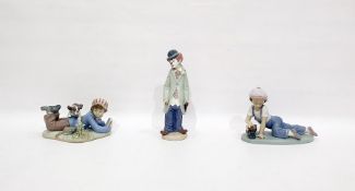 Lladro porcelain figure of a clown, Lladro porcelain figure of a lying boy with book and another
