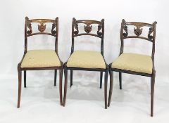 Set of four Regency simulated rosewood dining chairs with anthemion and scroll carved backs, gold