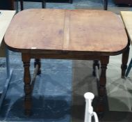 Early 20th century Majik dining table by Lignum, the draw-leaf table raised on baluster turned