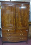 A Regency mahogany linen press, the 2 panelled doors enclosing 5 linen trays and brass hanging rail,