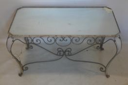 A vintage French wrought iron coffee table with mirrored top, H.53 W.98 D.56cm