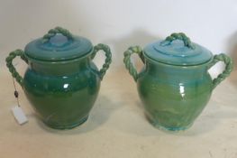 A pair of Persian cyan glazed pots and covers, with rope twist design handles, H.33cm (2)