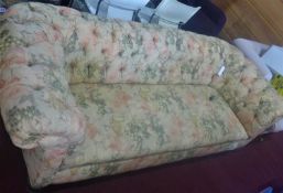 A Victorian 3 seat Chesterfield sofa, with floral upholstery, raised on carved legs and castors