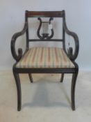 A Regency style brass inlaid mahogany scroll armchair
