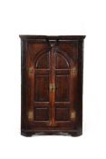 A George III oak standing corner cupboard