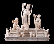 ϒ A Japanese Sectional Ivory Group of Dancers and Musician on a raised dais within a railed fence