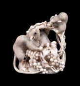 ϒ A Japanese Ivory Okimono carved to depict a woven basket overflowing with grapes