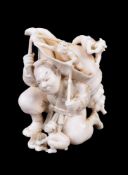 ϒ KOGYOKU: A Japanese Ivory Okimono of a Yamabushi kneeling under the weight of a giant conch shell
