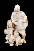 ϒ IKKOSAI: A Japanese Ivory Okimono of a man and his two children as street performers