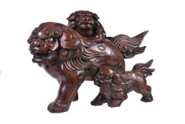 A Japanese Hinoki () Wood Sculpture of a mother shishi striding along with her two cubs