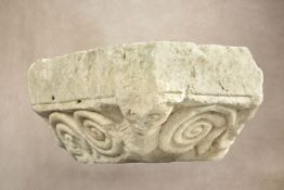 A carved limestone column capital,