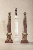 A pair of painted faux porphyry and parcel gilt metal models of obelisks