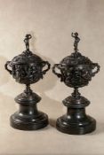 A pair of substantial Continental patinated bronze and marmo nero Belgio mounted twin handled urns i