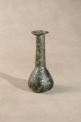 A Romano-Egyptian iridescent green glass unguentarium