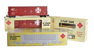 A collection of six Aristocraft railway box cars and low-loaders