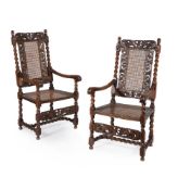 A pair of Charles II caved walnut armchairs