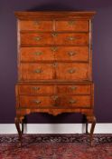 A George II figured walnut chest on stand
