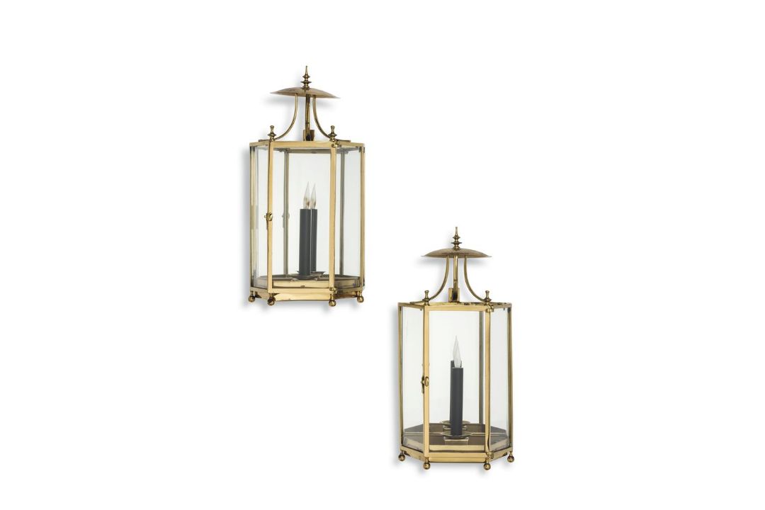 A pair of gilt metal and glazed wall lanterns, 20th century, each of polygonal section, beneath a
