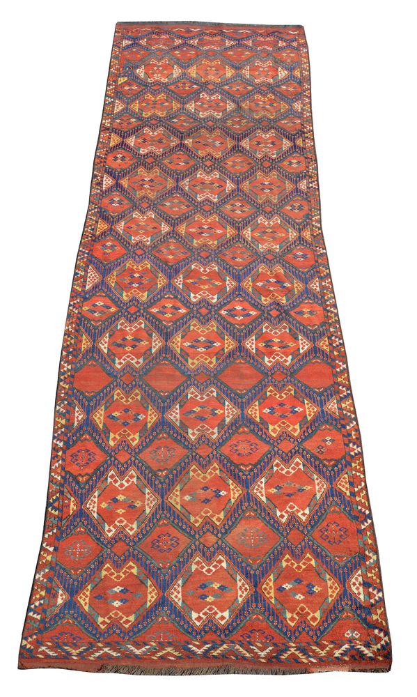 A Beshir carpet, the royal blue field with rows of indented polychrome lozenges containing