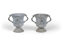 A pair of lead garden urns in William and Mary taste, 20th century, each twin handled body relief