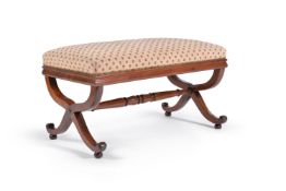 A George IV mahogany and upholstered centre stool, circa 1830, the upholstered top above x-frame