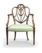 A George III carved mahogany shield back armchair, in the manner of Hepplewhite, with a Prince of