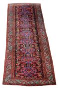 A Kurmurjur Kula carpet, the wine madder field with nine medallions, flowerheads and vines on