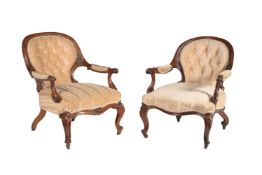 A matched pair of Victorian walnut and upholstered open armchairs