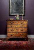 A George II figured walnut and feather banded chest of drawers, circa 1735