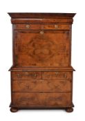 A Queen Anne walnut and feather banded escritoire, circa 1710