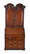 A Queen Anne 'red' walnut double dome bureau bookcase, circa 1710