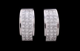 A pair of diamond half hoop earrings
