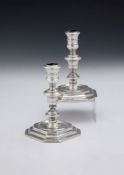 A matched pair of cast Britannia standard silver candlesticks