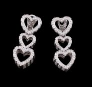 A pair of diamond triple heart ear pendants