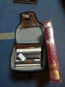 Collection of CDs in a Camera Bag and a Book