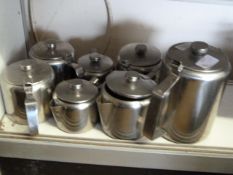 Seven Stainless Steel Water Jugs