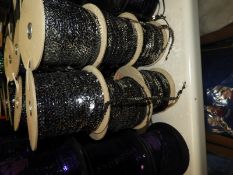 Six Rolls of Silver Sequins on Black Thread
