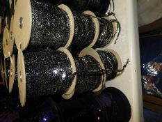 Six Rolls of Silver Sequins on Black Thread
