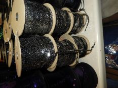 Six Rolls of Silver Sequins on Black Thread