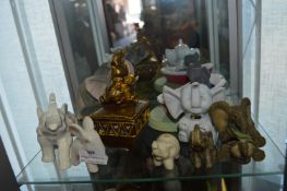 Nine Assorted Elephants Including One Having a Bat