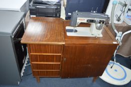 Older Sewing Machine in Cabinet by Seamstress